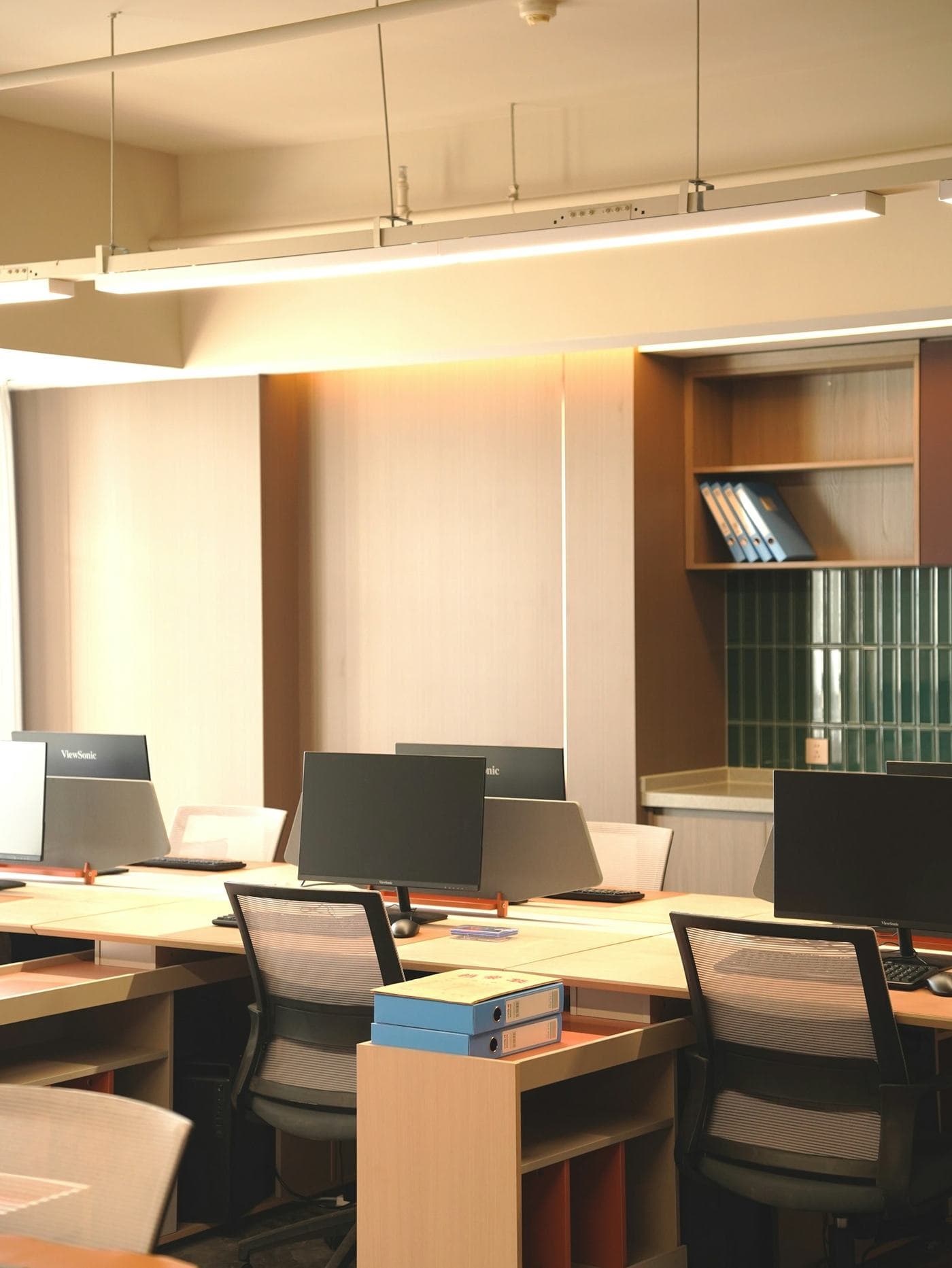 Bright office workspace with desks and monitors