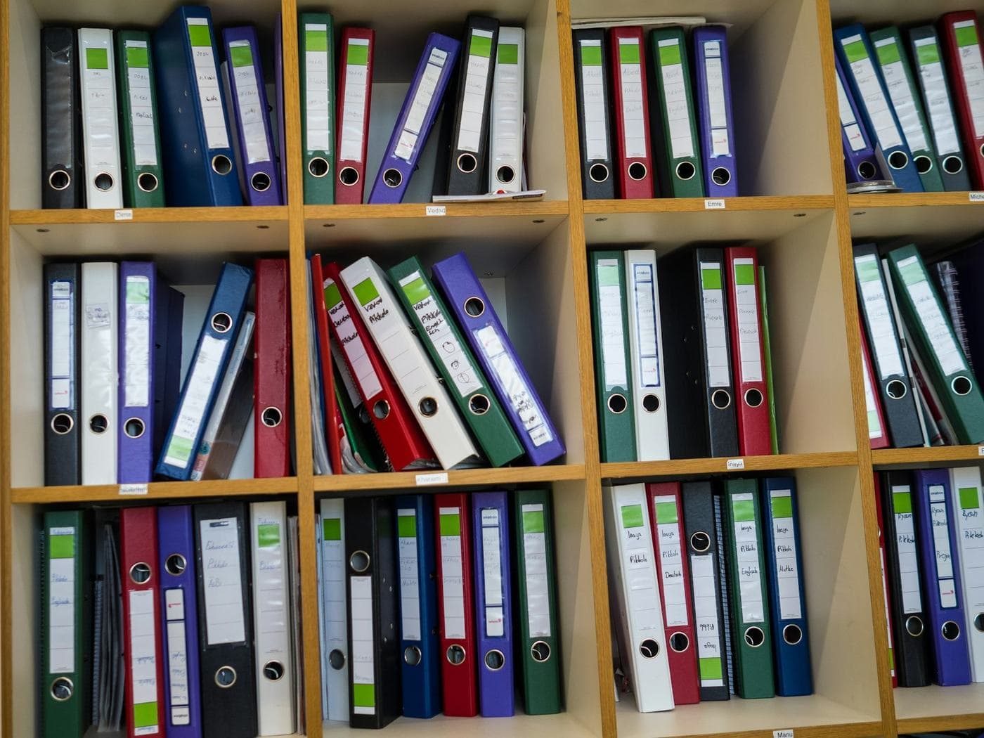 Labeled binders neatly arranged on office shelves